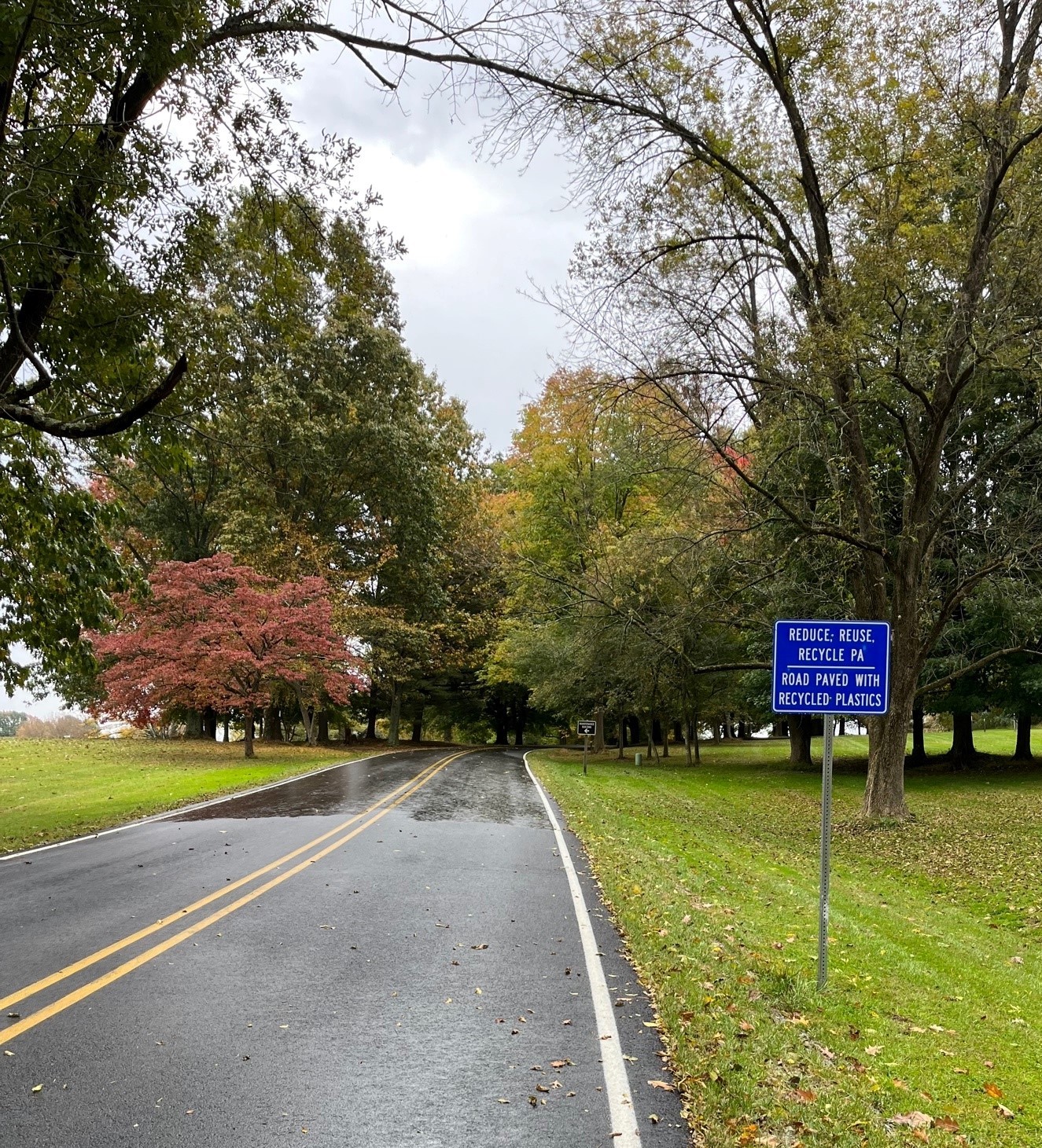 Ridley Creek State Park road with a sign announcing that it was paved with recycled plastic.