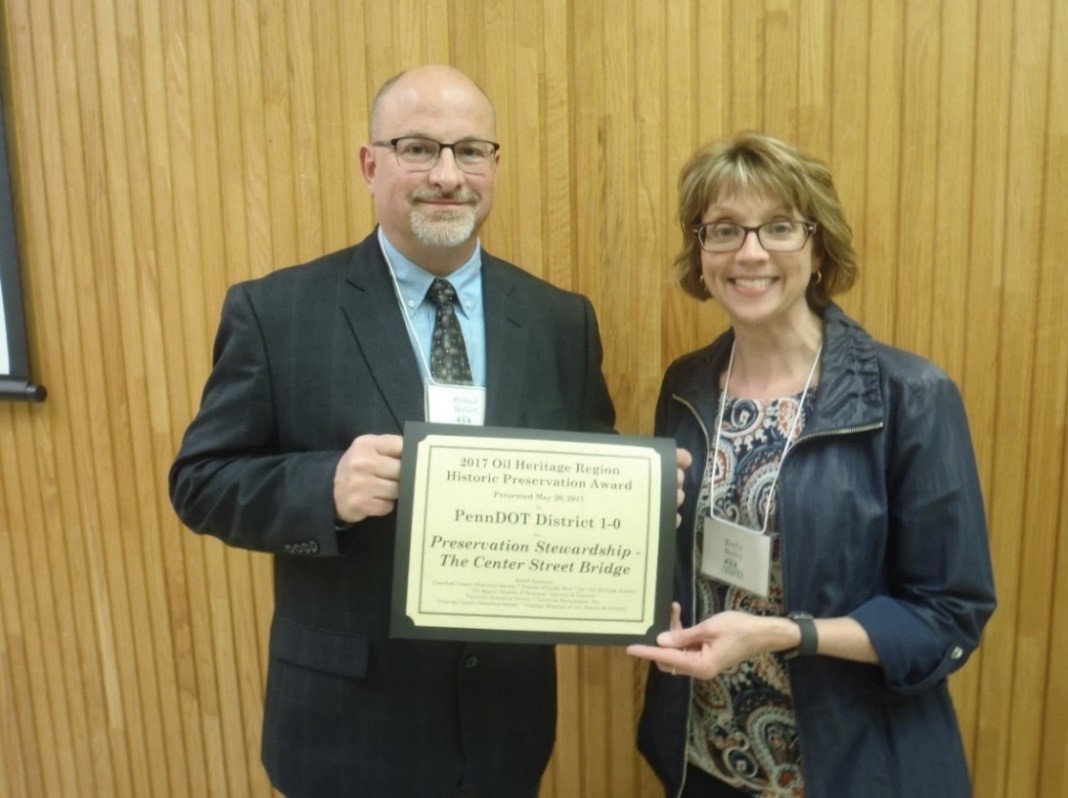 mike deibert accepts award from kathy baily
