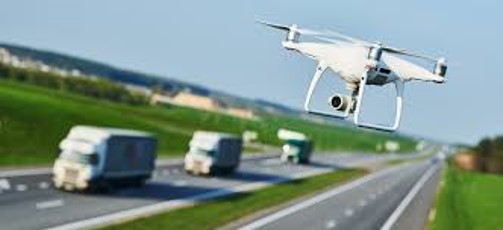 A drone flying along an interstate.