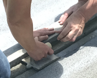 close-up of hands finishing concrete